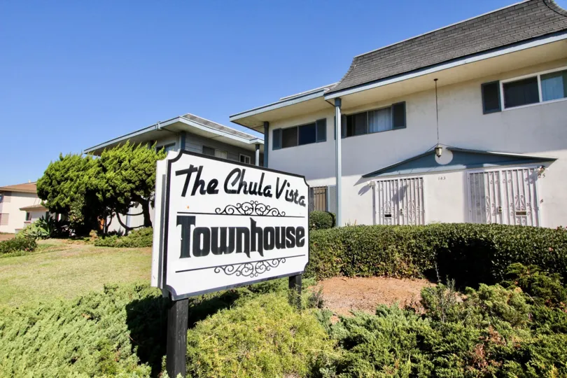 White sign with black writing on two post in front of Chula Vista townhomes at Chula Vista CA