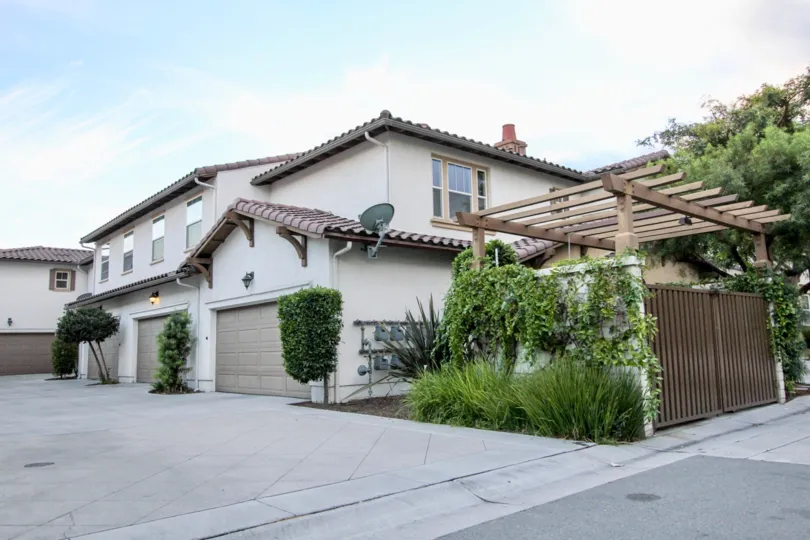 THE APARTMENT IN THE CORDOVA WITH THE SHUTTER, GATE, PLANTS, TREE, DISH ANTENNA