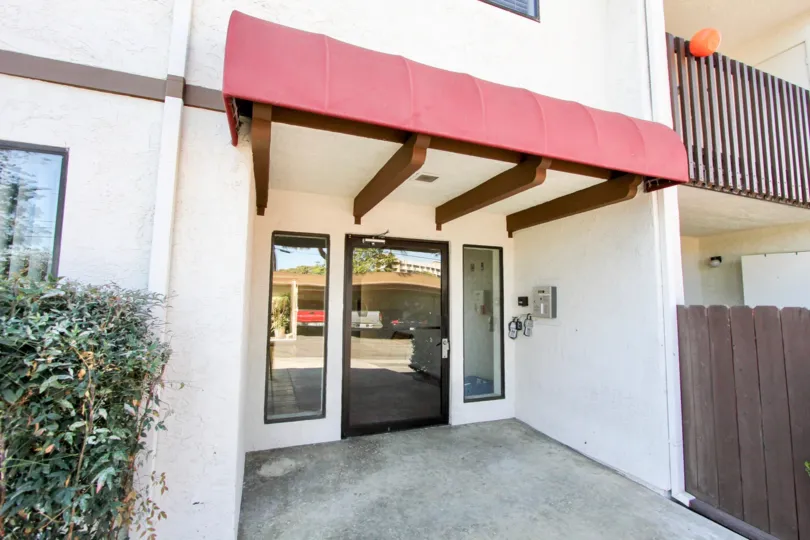A door surrounded by two windows at the Del Nava located in Chula Vista California