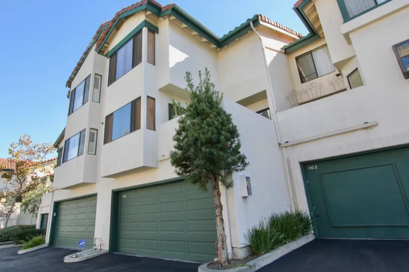 A low-rise residence with covered garages in the Eucalyptus Ridge community.