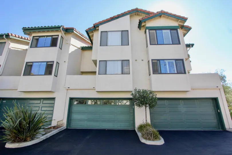 Three blue garages built into the Eucalyptus Ridge in Chula Vista CA