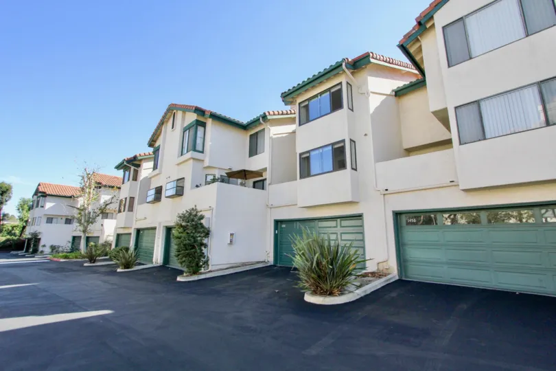 Blue garage doors at the bottom of condominiums inside Eucalyptus Ridge in Chula Vista CA