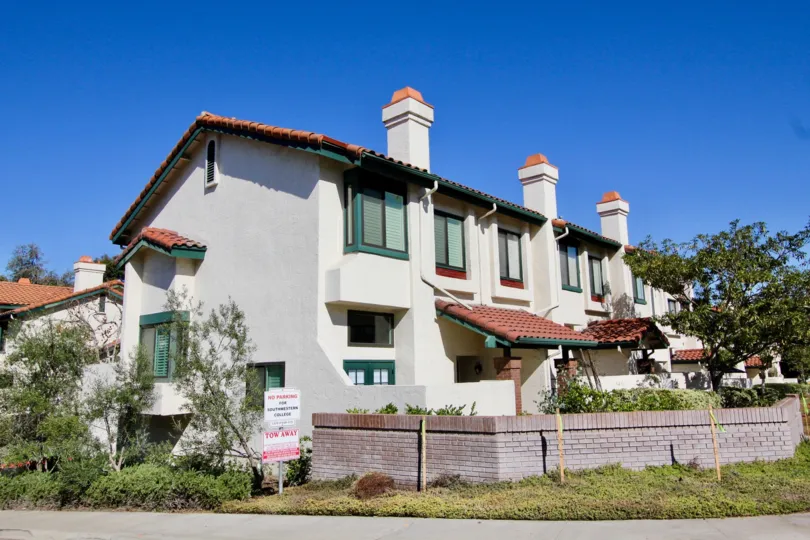 A short red brick fence surrounds the front of Eucalyptus Ridge condos