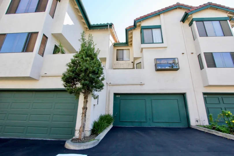Three garage doors at the bottom of town homes in Eucalyptus Ridge in Chula Vista CA