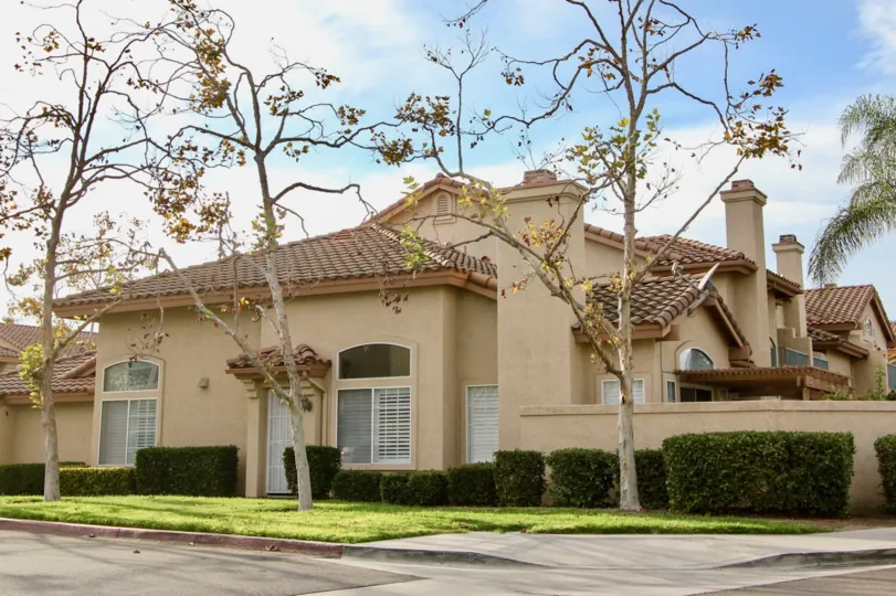 Light brown town homes with multiple chimneys inside Fairway Villas in Chula Vista CA