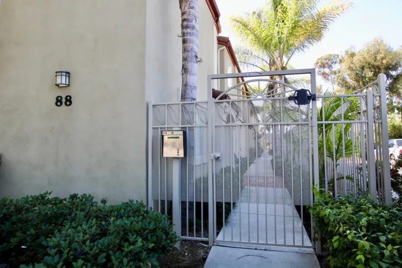 Locked entrance gate with call box at 88 Fourth Park Place, Chula Vista, CA.