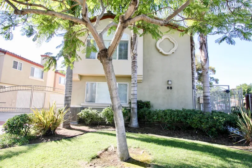 A large white decoration on the side of a building with trees inside fourth Park Place in Chula Vista CA