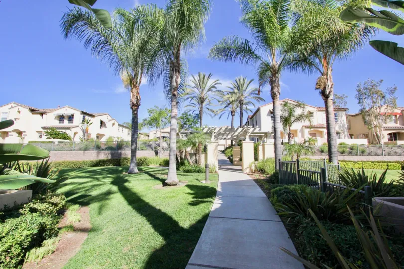 A white paved sidewalk that leads to Gold Rush in Chula vista ca