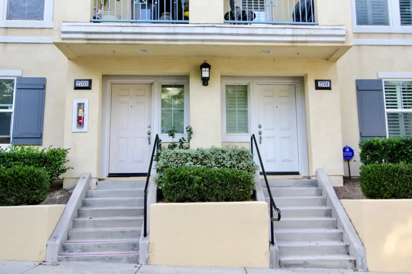 The entryway with gray doors to two units in the Greystone community.