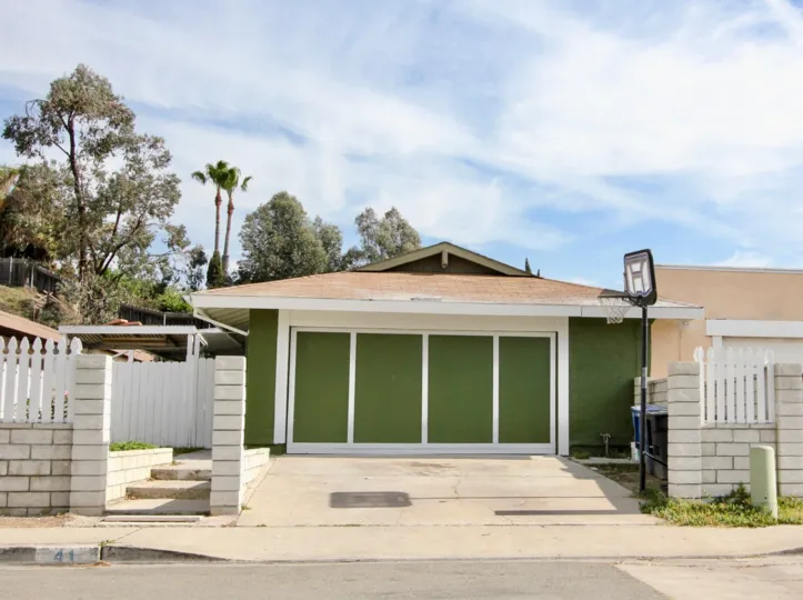 Beautiful home with garage and driveway and a yard in a community