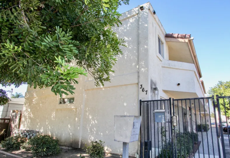 THE BUILDING IN THE JASMINE PLACE WITH THE CAR, BOX, TREES, STEEL GATE, PLANT