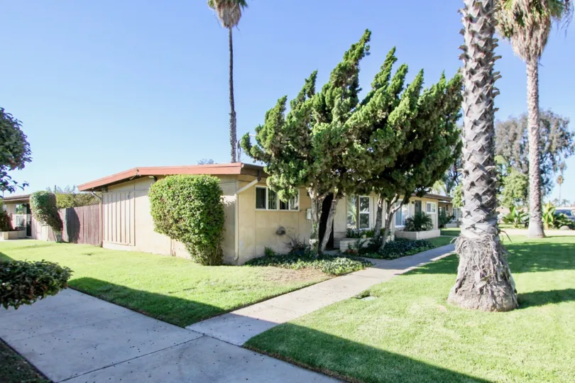 A sunny day in the Karen Condominiums with Gardens many types of trees and the house at Chula Vista in California