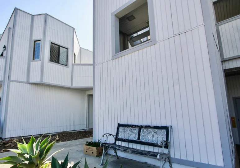 THE APARTMENT IN THE KIMBALL TERRACE WITH THE CHAIR, WINDOW, PLANTS, PATHWAY, DOOR