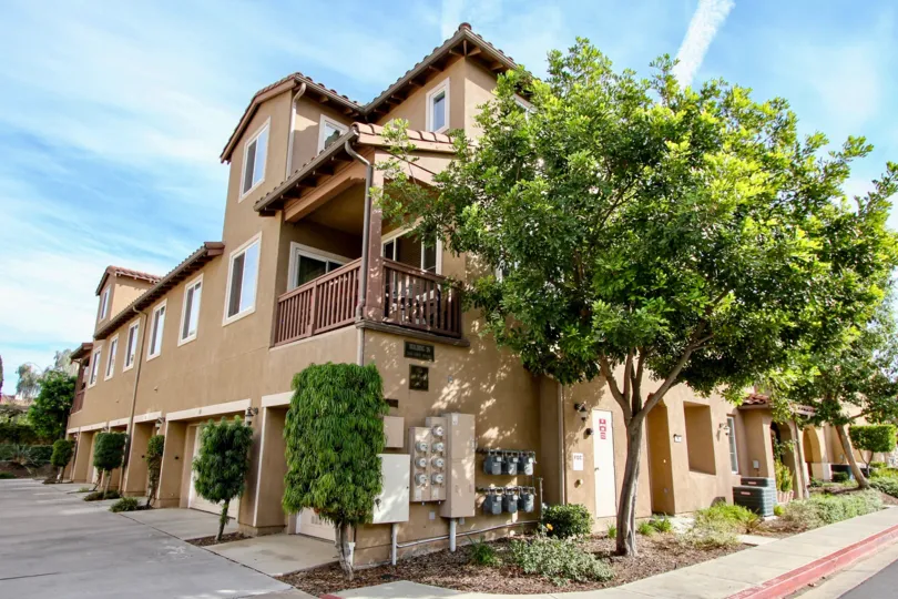 A sunny day in the area of Mar Brisa, gas meters, electric, meters, tree, balcony, condo, garage, driveway