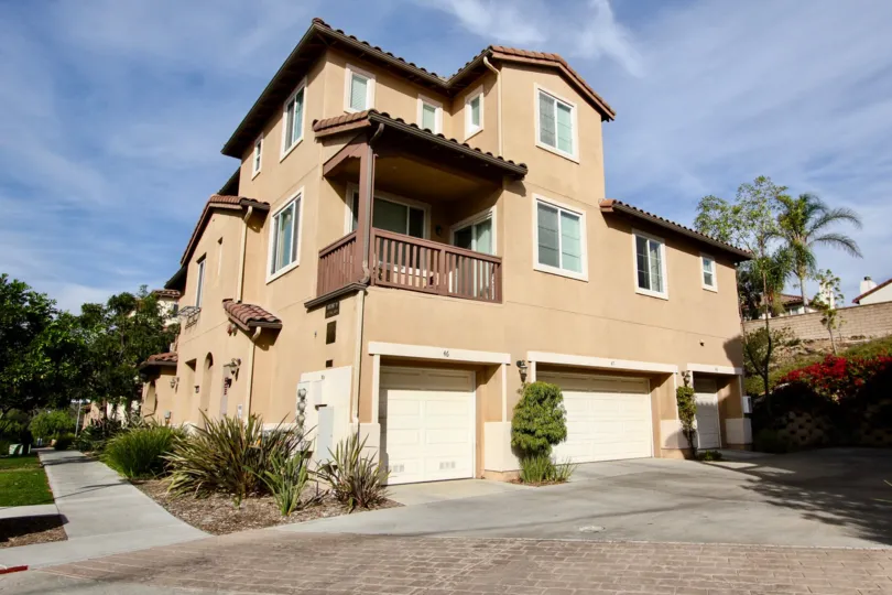 Exterior view of garages and balcony at Mar Brisa in Chula Vista, CA
