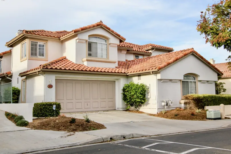 A traditional house painted in cream color of the Masters Collection community.