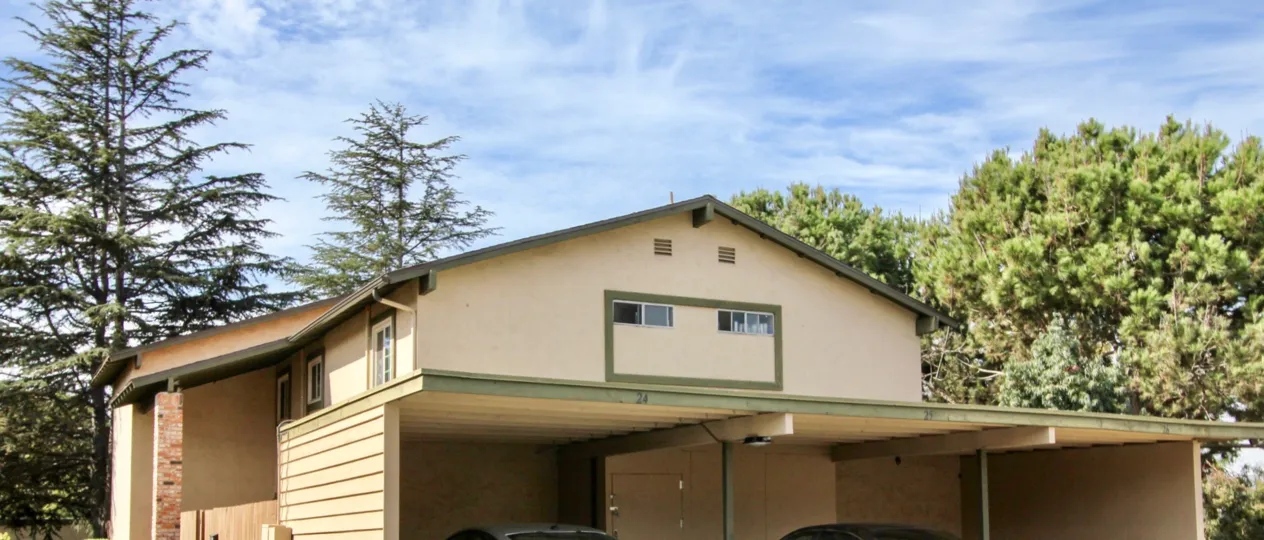 Two small vents sit above two windows on the Melrose Place Townhomes conods