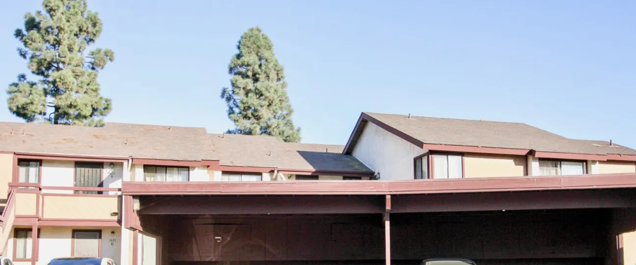 A sunny day in the area of Melrose Villas, outside, car port, cars, stairs, balcony, condos, trees