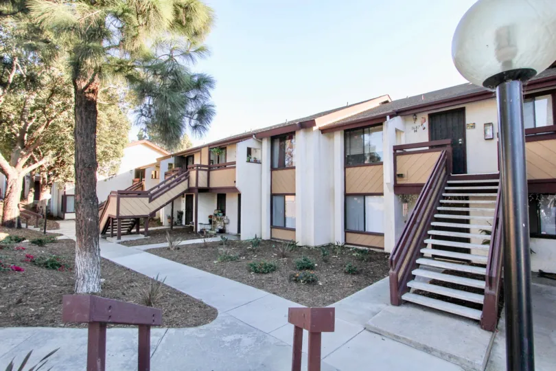 The pathway leading to several apartments in Melrose Villas in California.