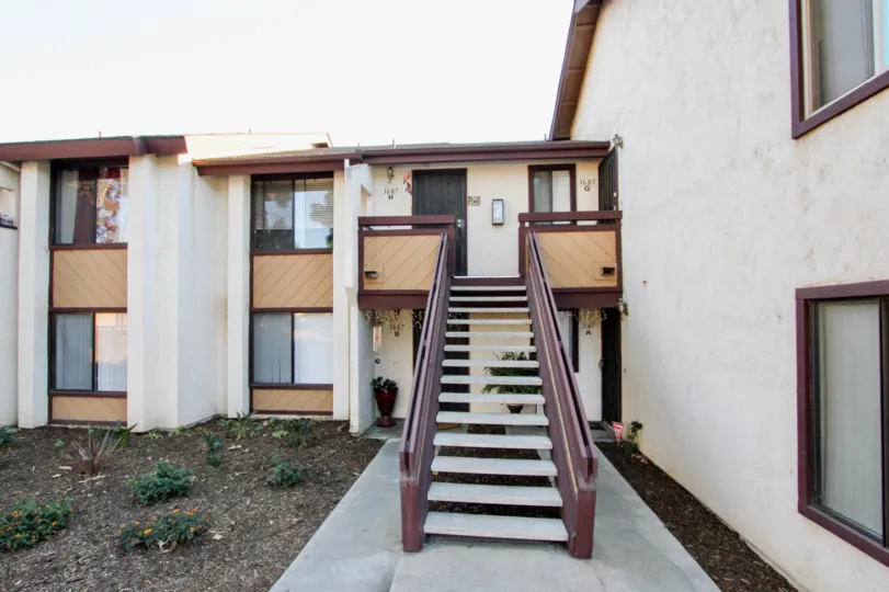 A sunny day in the area of Melrose Villas, outside, dirt, stairs, balcony, window