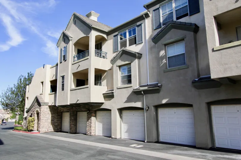 A contemporary three-storey townhouse in Mer Soleil community covered in grayish hue.