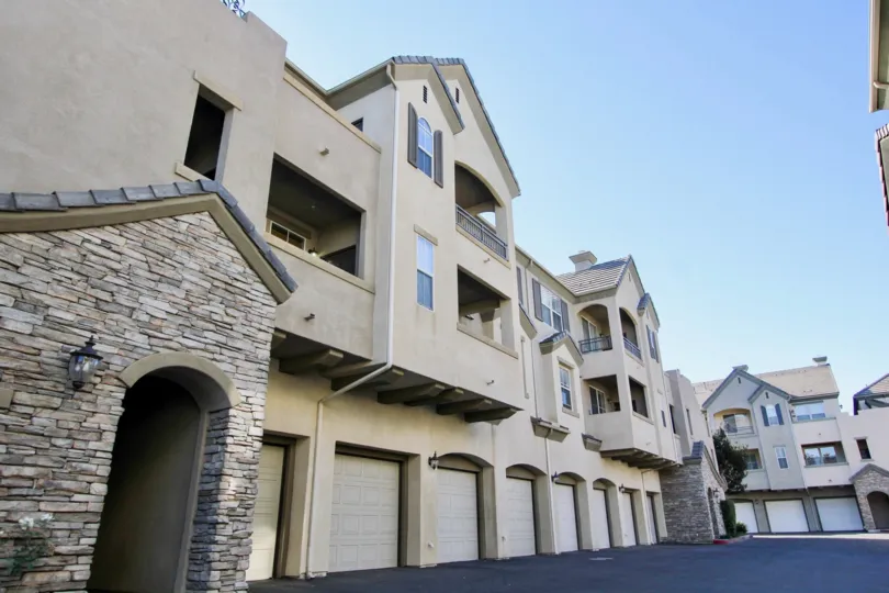 Stone entrance way to multi-unit condos at Mer Soleil with above-garage units.