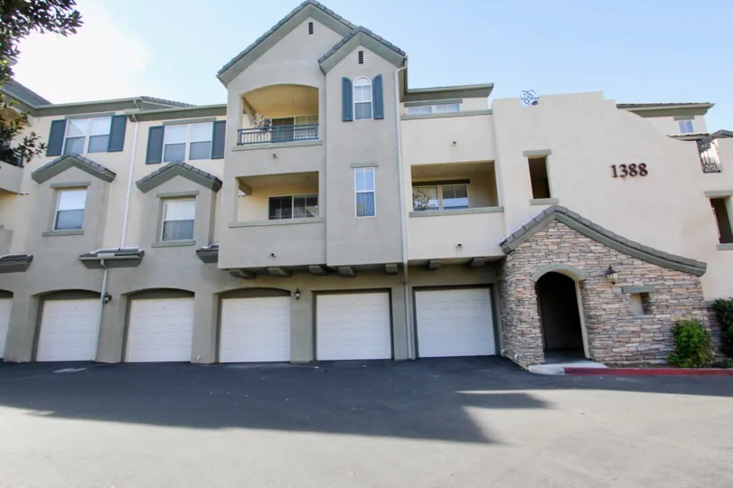 A sunny day in the area of Mer Soleil, outside, driveway, garages, door, balconies, bush