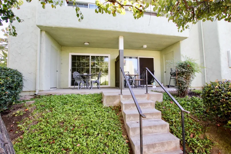 a nice stairway entrance with a front porch for mornings and plenty of greenery