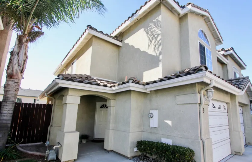 The front door entrance into a townhome sits on an angle in an alcove at Moss Villas