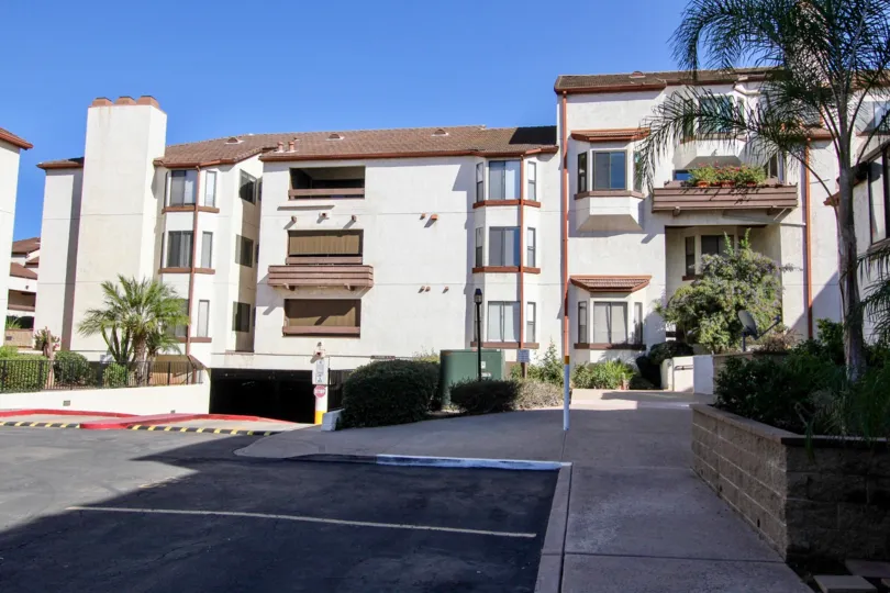 A three floored white apartment block in Parkwoods as seen from the car park.