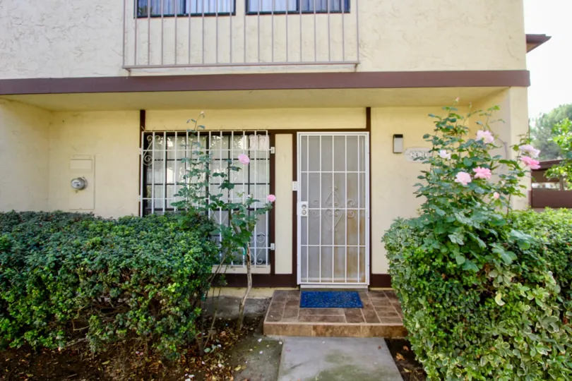 front entrance decorated trees plants and rose flowers in front of the building Rancho Rios