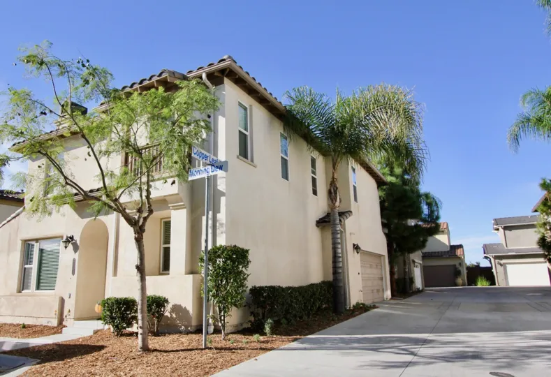 The sunny view from a street corner in a Saguaro townhouse community