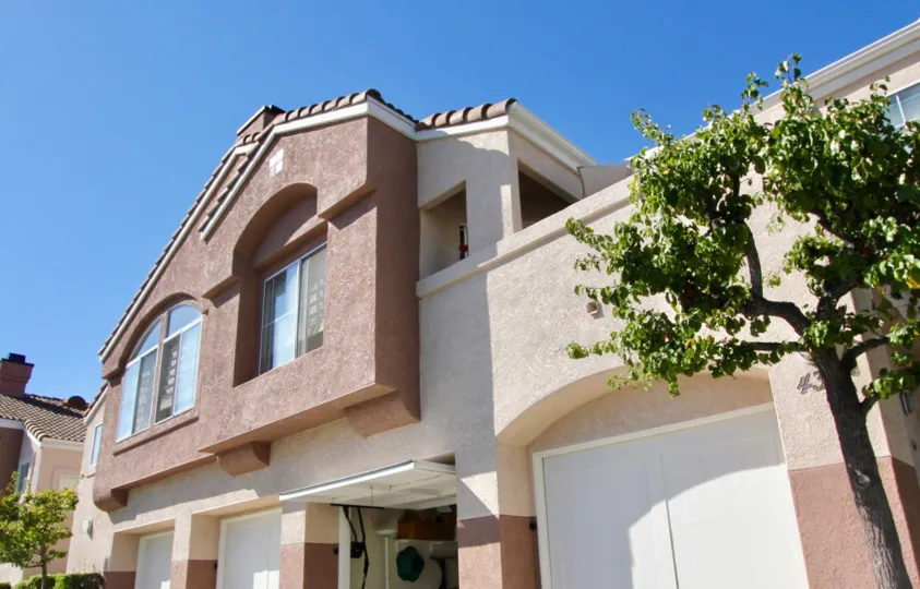 big house with a good architecture, subtle sophisticated paint job in a bright sunny da