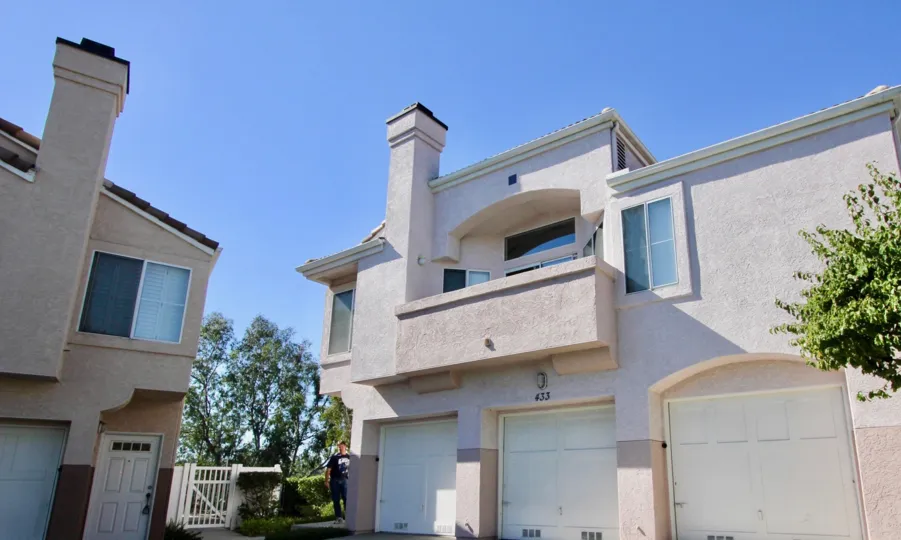 A two-storey residence in the Sanibelle community with closed garages.