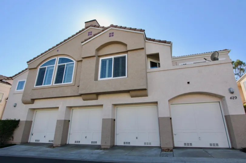 A light brown garage building in a shade setting at Sanibelle.