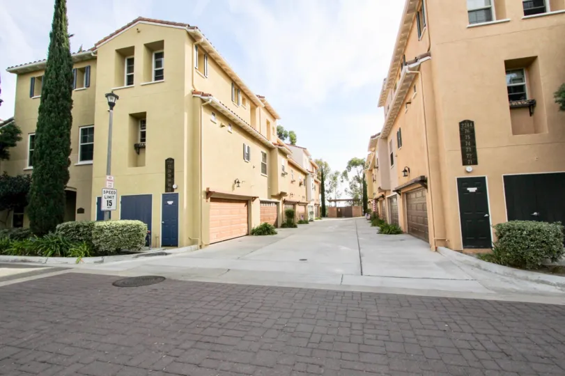 Clean and clear road in frond and between buildings and trees and plants in front of the buildings in Sedone