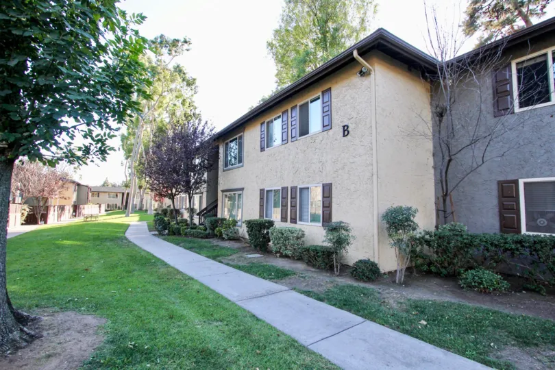 Sunny day front view with trees and walkway, Shadow Pines Community, Chula Vista, CA
