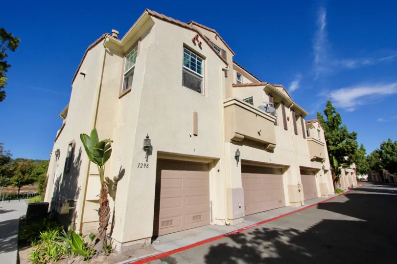 Double and single car homes with stucco exteriors and backlane at Silver Sage
