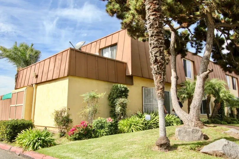 A sunny day in the Stonebridge II with many types of trees, flowers and the house at Chula Vista in California