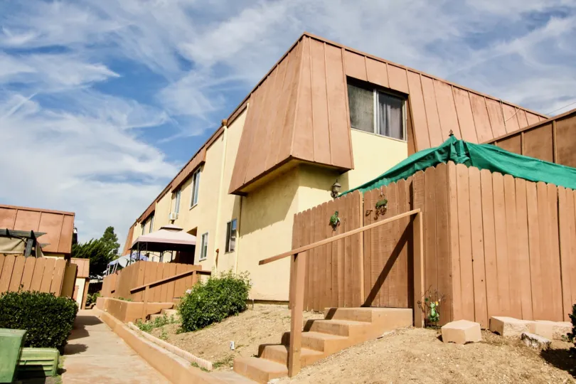 The Stonebridge II apartments with tall wood fences and minimal landcaping