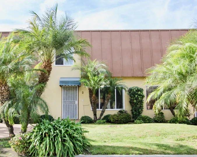 Clean and clear front yard have trees and plants in front of building in Stonebridge II