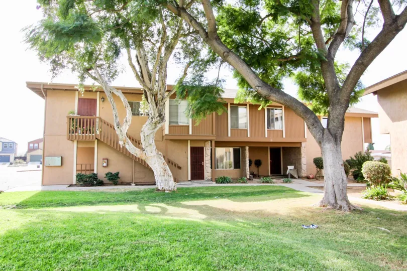 A beautiful view on a sunny day of lawn with trees in front of a house in stonebridge area of Chula Vista