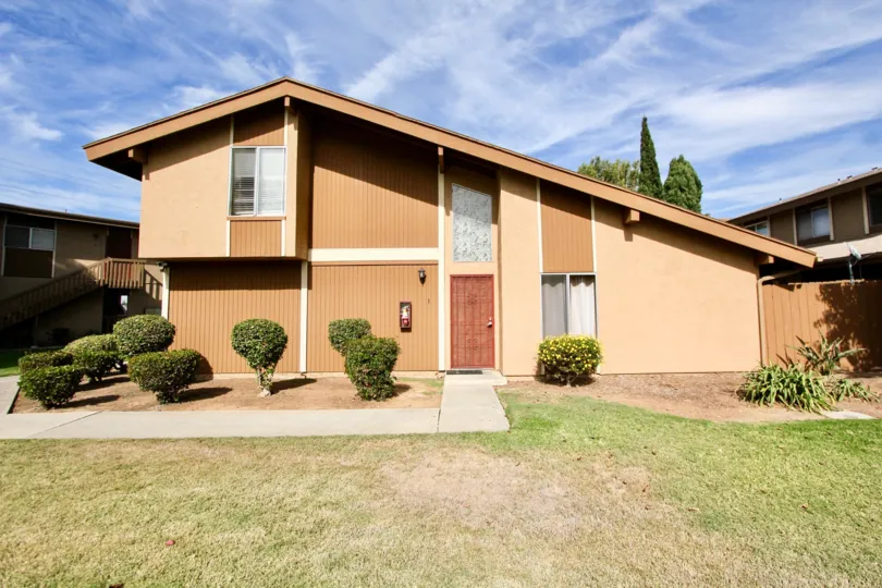 The outside of. Stonbridge home showing the front lawn and walkway in Chula Vista
