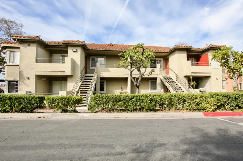 Front of Sunbow Villas with staircases leading to the upstairs apartments in Chula Vista, Ca
