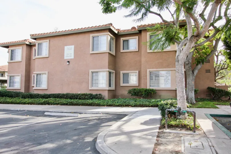 A sunny day in the area of Sunbow Villas, parking lots, gas meter, tree, condos, windows