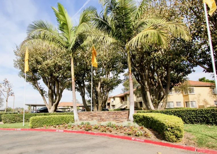 A Sunnyday in Sunbow Villas have trees and flag and plants decorated in front