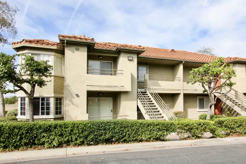 An apartment building in Sunbow Villas, bordered by trimmed hedges