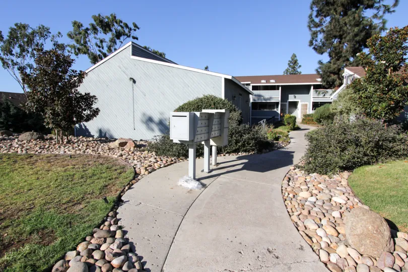 Sidewalk leading to apartment building with mailboxes on the side at Telegraph Canyon Terrace in Chula Vista, Ca.