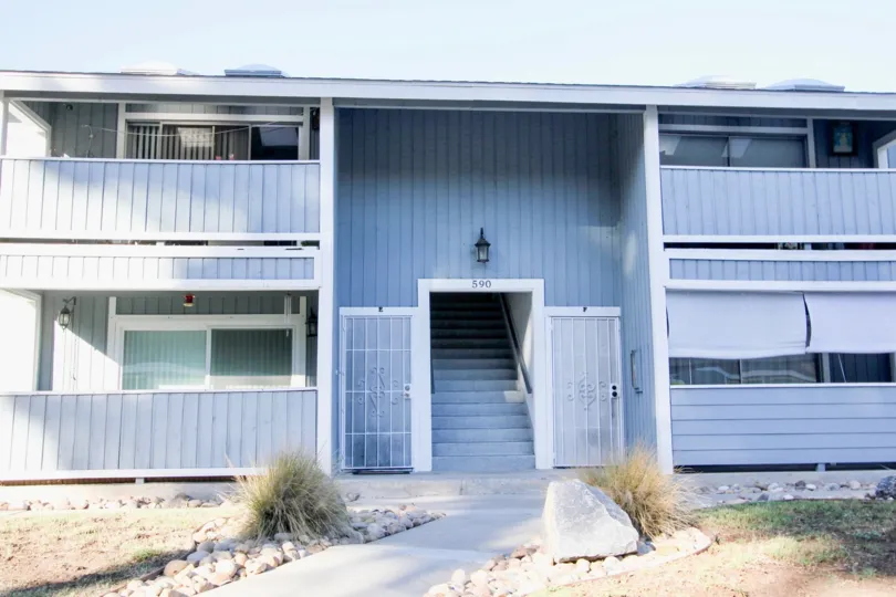 A beautiful blue four unit town home during a sunny day in the Telegraph Canyon Terrace community in Chula Vista California.