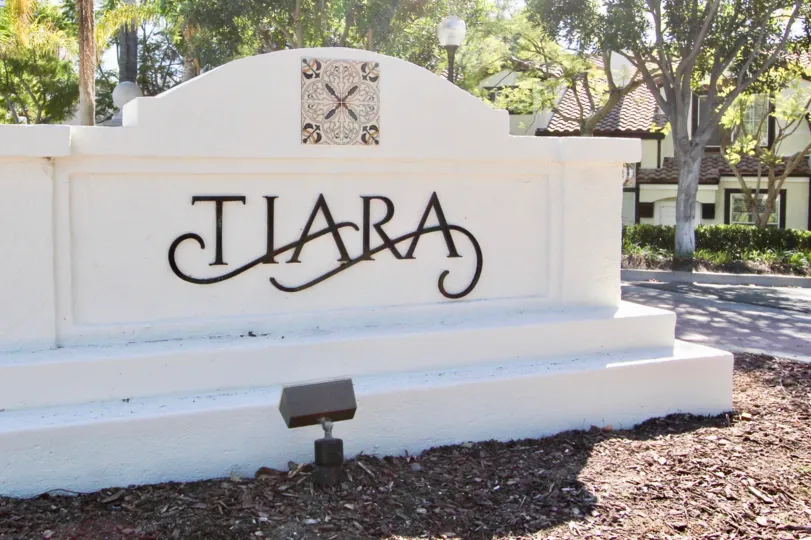 A concrete signage at the Tiara community with one decorative tile.